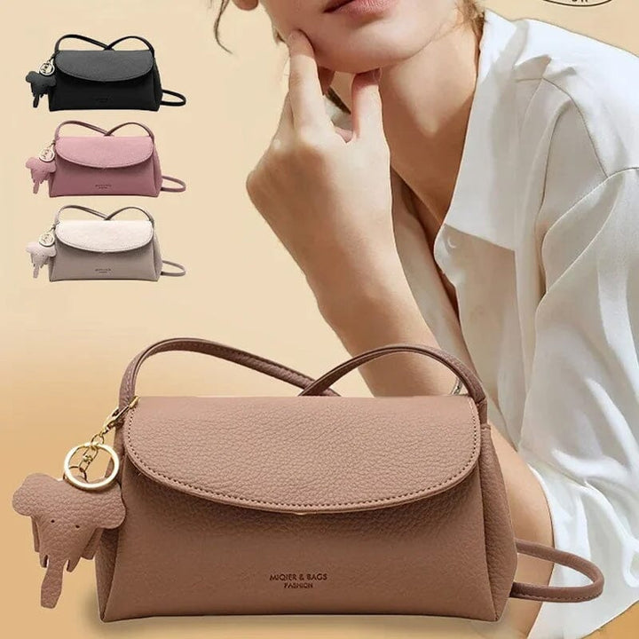 Naisten muoti crossbody laukku, vaaleanpunainen PU-nahka, norsuriipus koriste, tyylikäs ja käytännöllinen päivän asuste.
