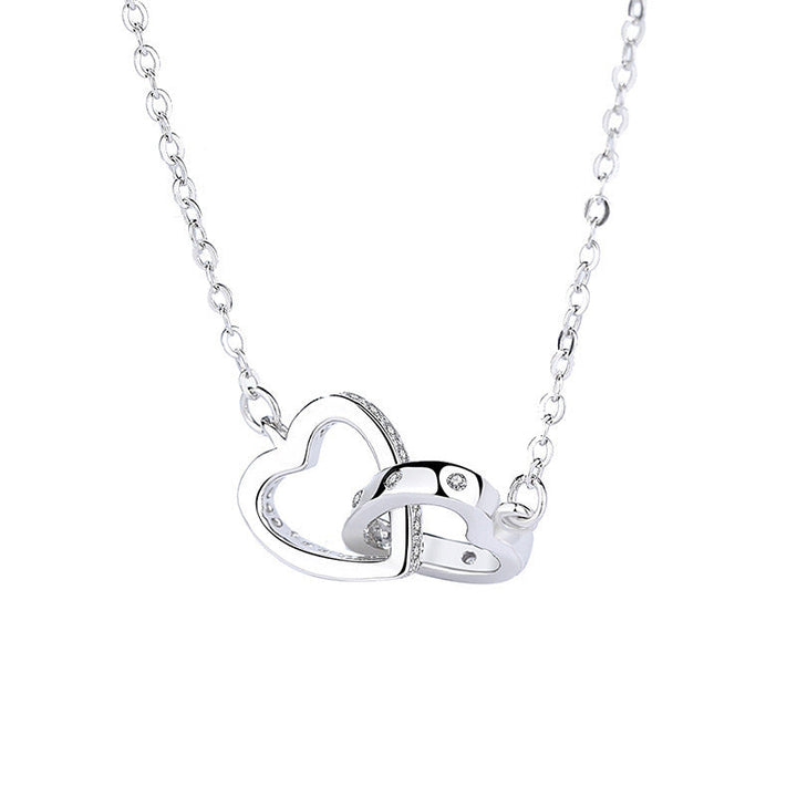 Dame halskæde med forviklede hjerter i rosaguld, prydet med cubic zirconia sten.