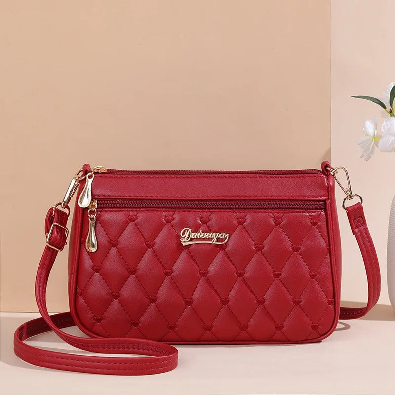 Dame elegant broderet crossbody taske, kompakt størrelse, subtil broderi, justerbar skulderrem.