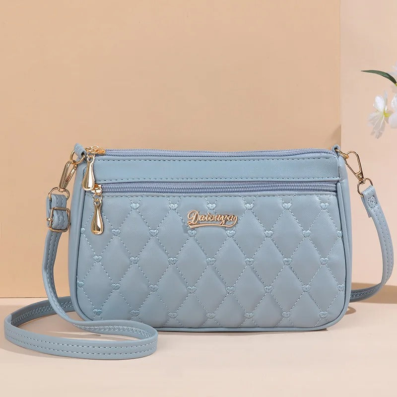 Dame elegant broderet crossbody taske, kompakt størrelse, subtil broderi, justerbar skulderrem.