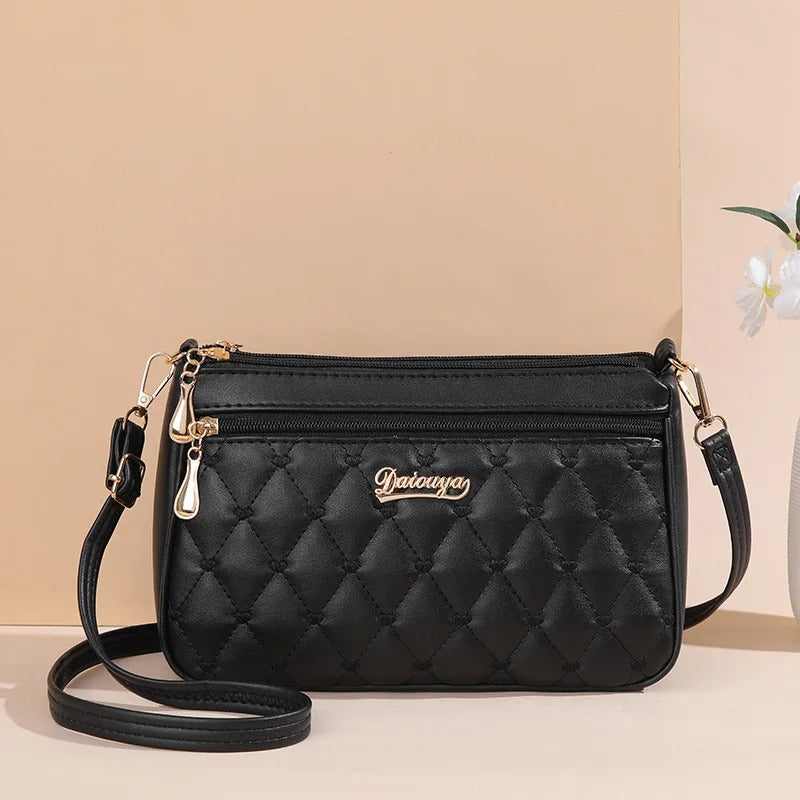 Dame elegant broderet crossbody taske, kompakt størrelse, subtil broderi, justerbar skulderrem.