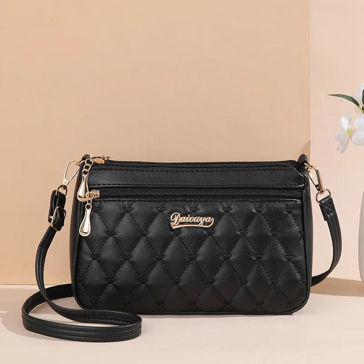 Dame elegant broderet crossbody taske, kompakt størrelse, subtil broderi, justerbar skulderrem.