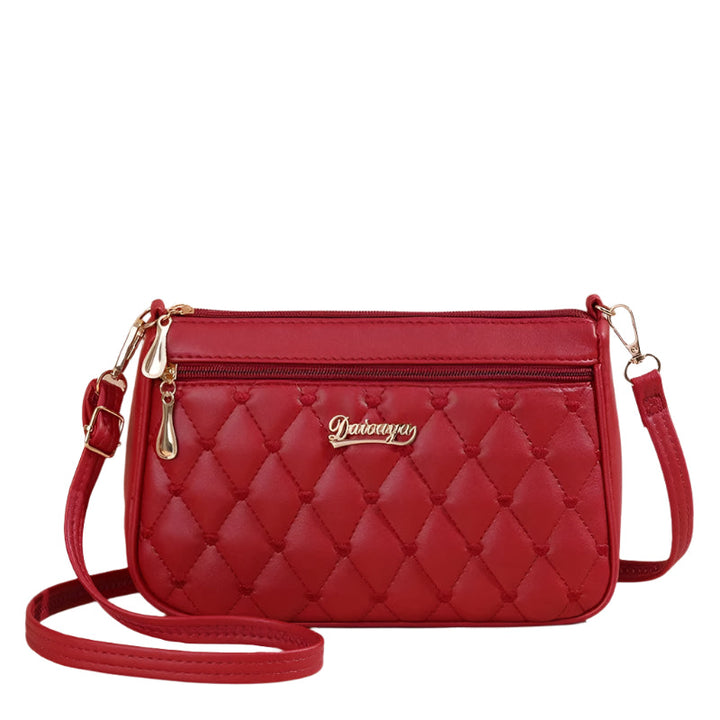 Dame elegant broderet crossbody taske, kompakt størrelse, subtil broderi, justerbar skulderrem.