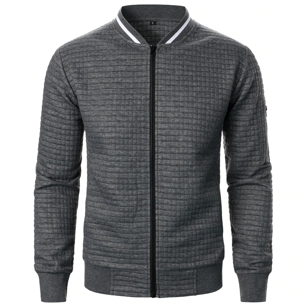 "Rento miesten vetoketjullinen ruudullinen neuletakki, harmaa sävy, etukiinnitys ja resorihelmat. Monikäyttöiseen tyyliin."