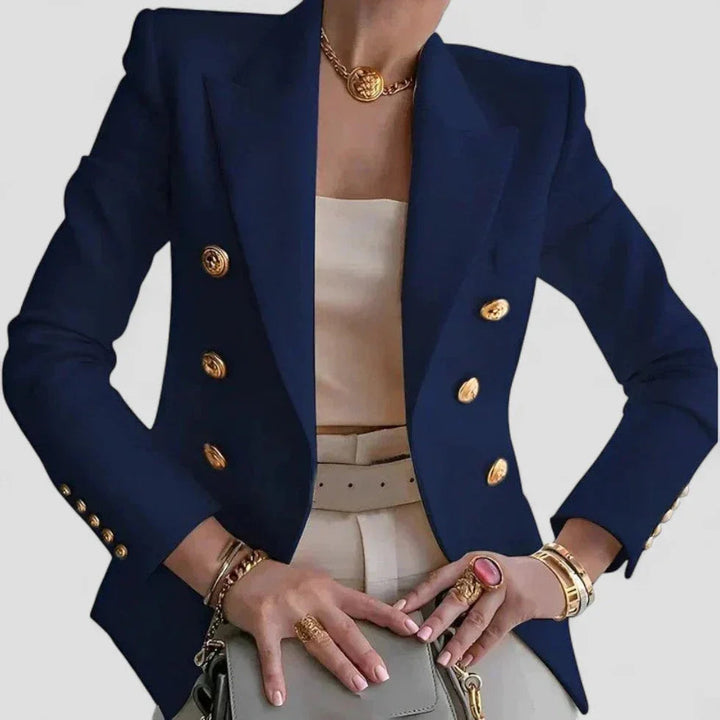 Elegant dame dobbeltspændt blazer med guldfarvede knapper, skræddersyet pasform og strukturerede skuldre.