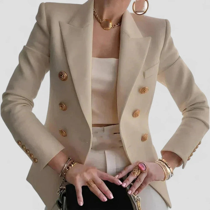 Elegant dame dobbeltspændt blazer med guldfarvede knapper, skræddersyet pasform og strukturerede skuldre.