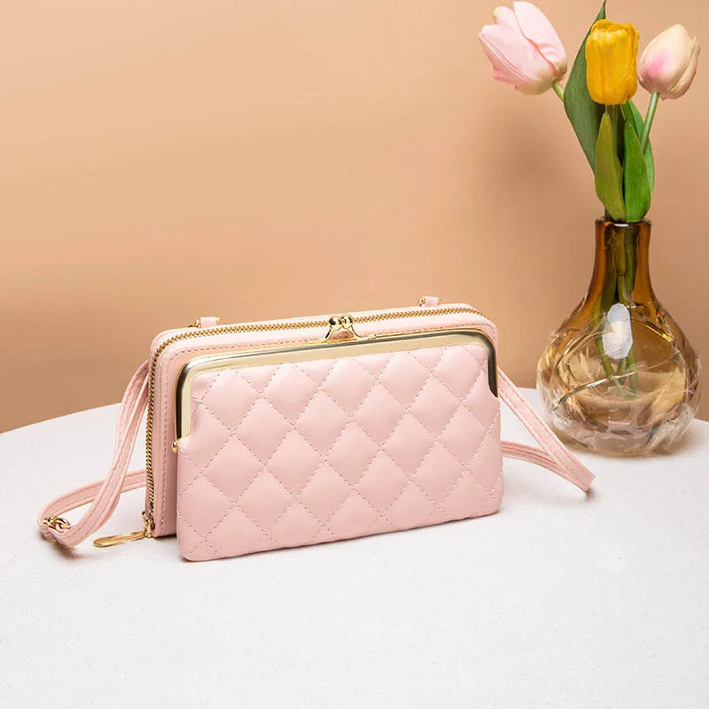 Elegant dame kompakt crossbody taske i vegansk læder i sort, med justerbar skulderrem og flere rum.