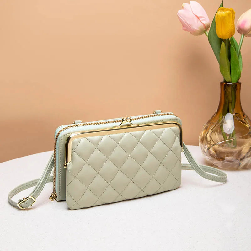 Elegant dame kompakt crossbody taske i vegansk læder i sort, med justerbar skulderrem og flere rum.