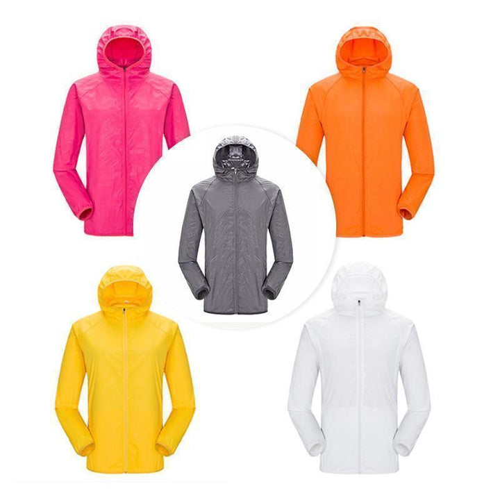 Unisex let vandtæt vindjakke, minimalistisk design, grå farve og skjulte lommer til udendørs brug.