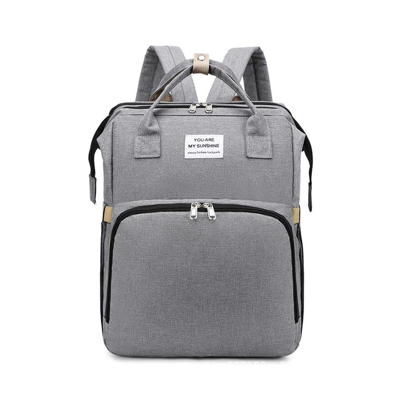 Unisex babyplejerep med seng, mange lommer til babyudstyr, foldet sammen, gråt Oxford-stof.