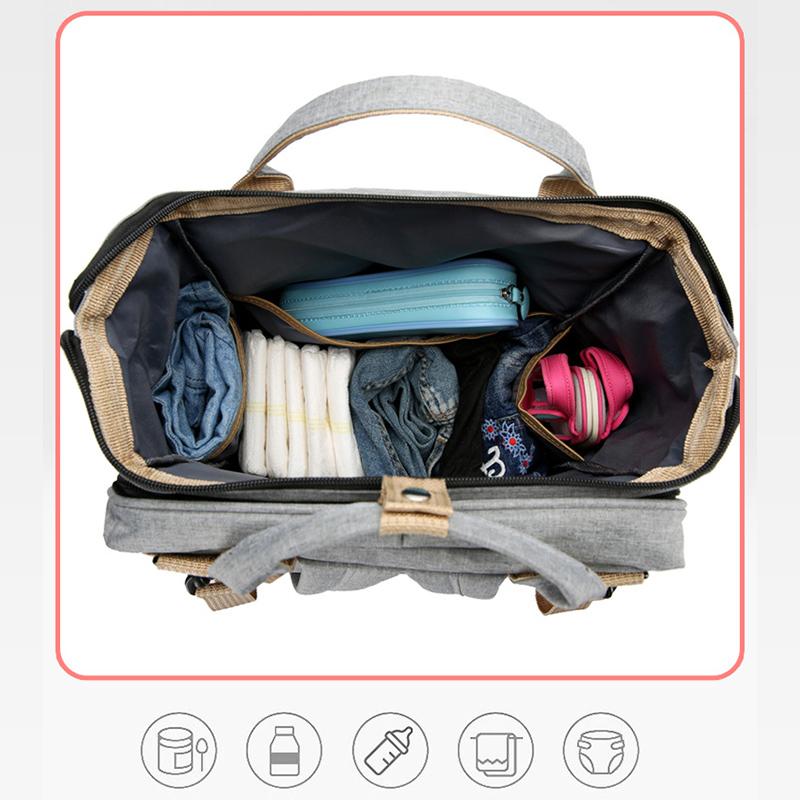 Unisex babyplejerep med seng, mange lommer til babyudstyr, foldet sammen, gråt Oxford-stof.