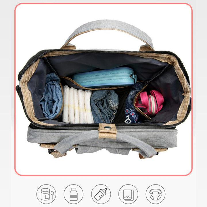 Unisex babyplejerep med seng, mange lommer til babyudstyr, foldet sammen, gråt Oxford-stof.