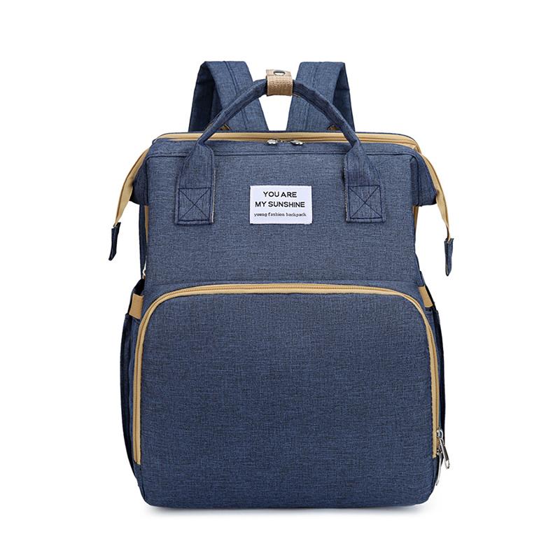 Unisex babyplejerep med seng, mange lommer til babyudstyr, foldet sammen, gråt Oxford-stof.