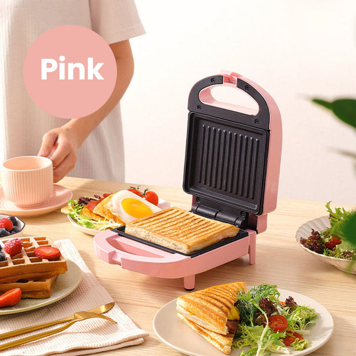 Pink og rød multifunktionel morgenmadsgrill, kompakt og pladsbesparende til køkkenet, velegnet til stegning og grillning
