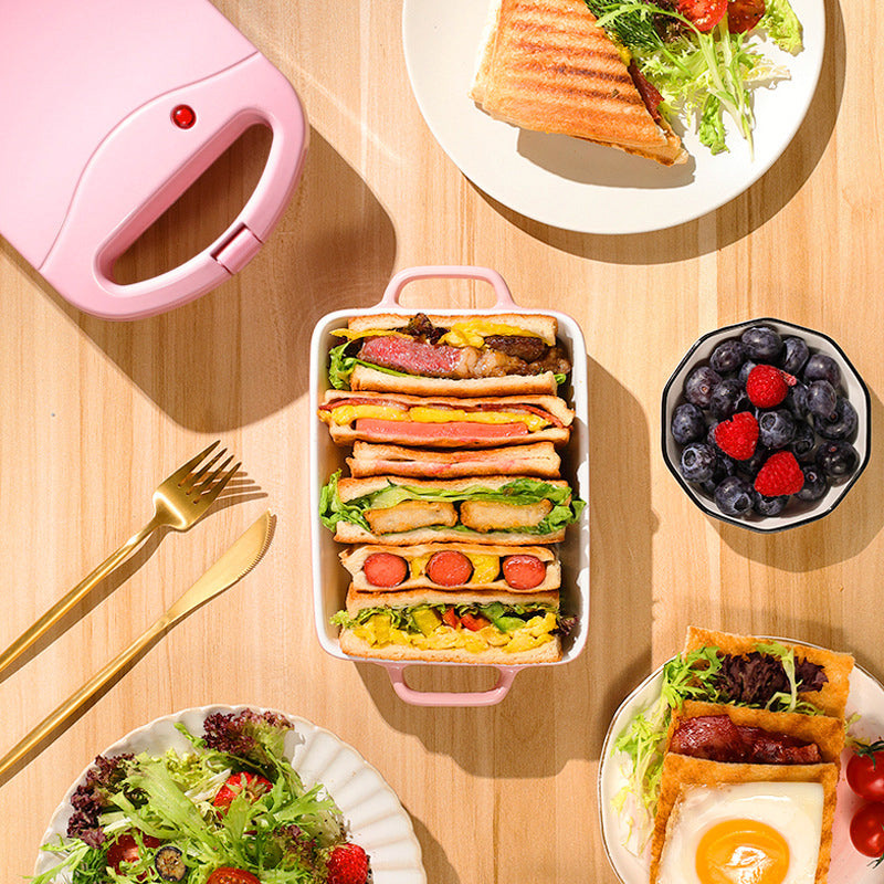 Pink og rød multifunktionel morgenmadsgrill, kompakt og pladsbesparende til køkkenet, velegnet til stegning og grillning