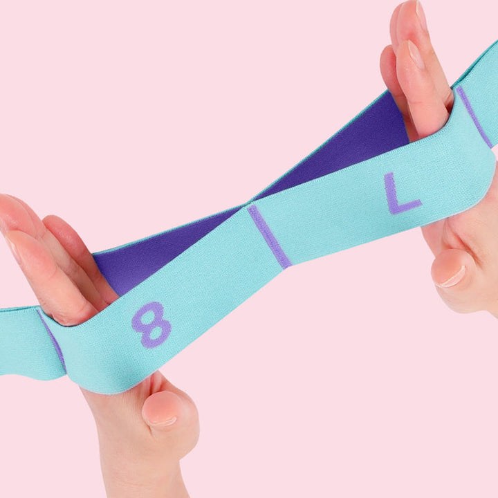 Pink og blå modstandsdygtig elastik med flere løkker til fleksibilitetstræning, forbedrer kropskontrol.