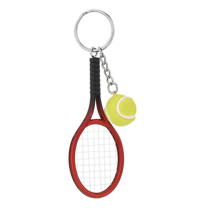 Farverig mini tennisracket nøglering i seks farver: rød, grøn, lilla, sølv, guld og blå.
