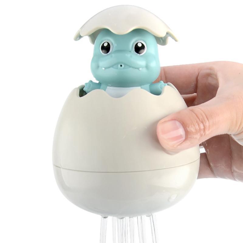 Farverigt babylegetøj til badetid, med gule andeæg og blå dinosauræg, der bringer glæde i badet.