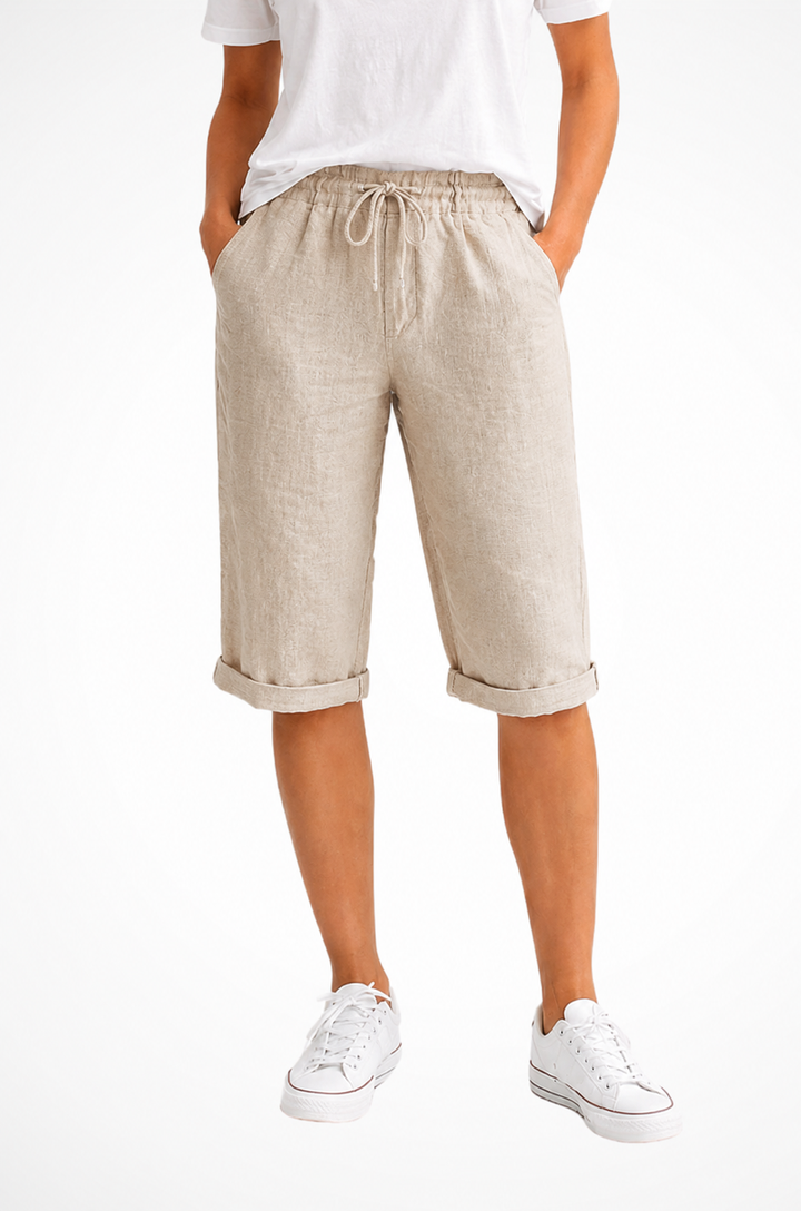 Stilfulde cropped capribukser til kvinder. Afslappet pasform, åndbar hørblend og justerbar talje til sommer.