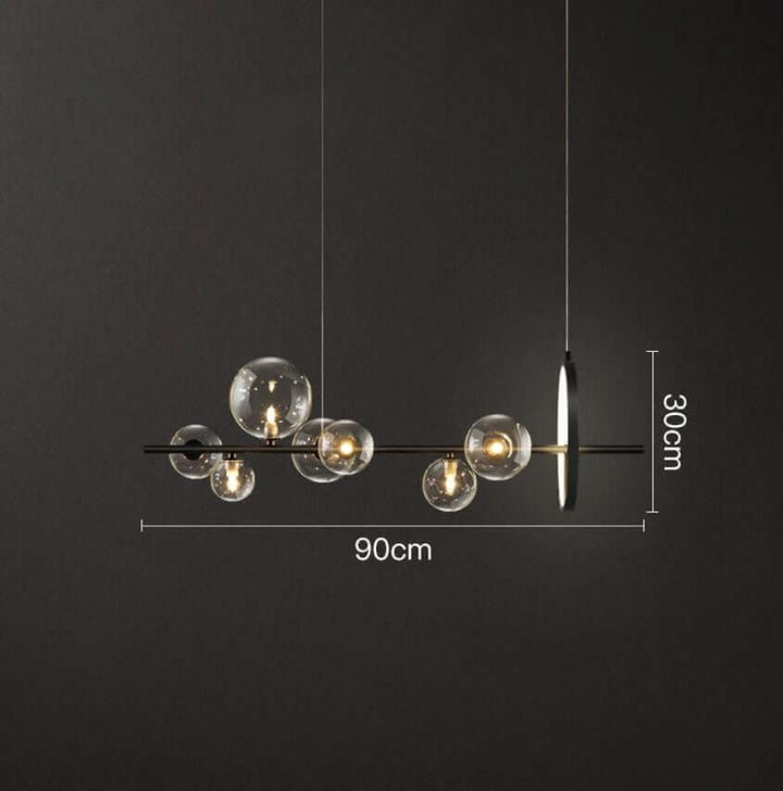 Glasboble pendellampe i et stuemiljø