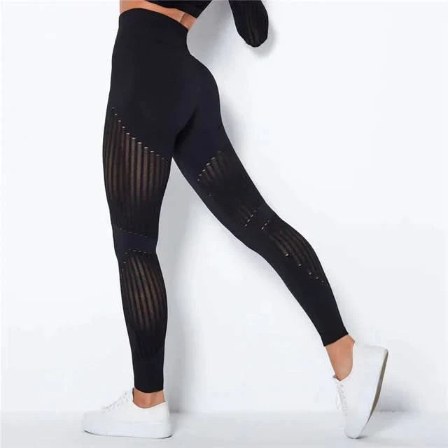 Højtaljede sorte dame leggings med anti-cellulite kompression. Udglattende og støttende til yoga og sport.