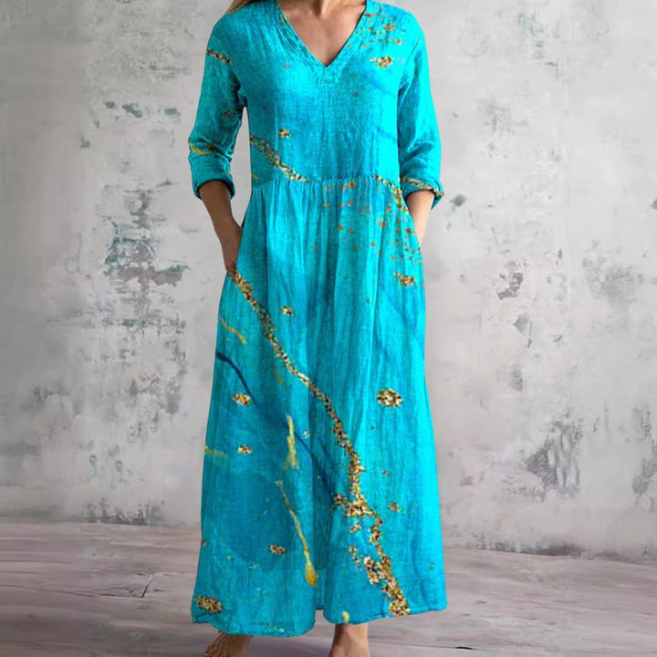 Elegant blomstret V-hals maxikjole til kvinder. Afslappet sommerkjole med smukt print og feminin stil.