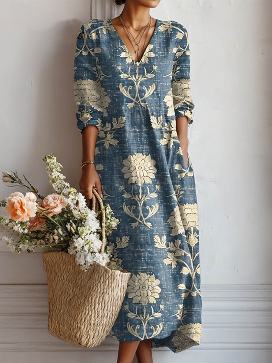 Elegant kvinders midi kjole med blomsterprint og V-hals, perfekt til sommer og festlige lejligheder.