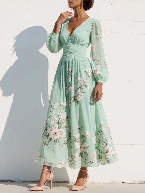 Stilfuld dame midi-kjole med blomsterprint, elegante ballonærmer og V-udskæring. Perfekt til fest.
