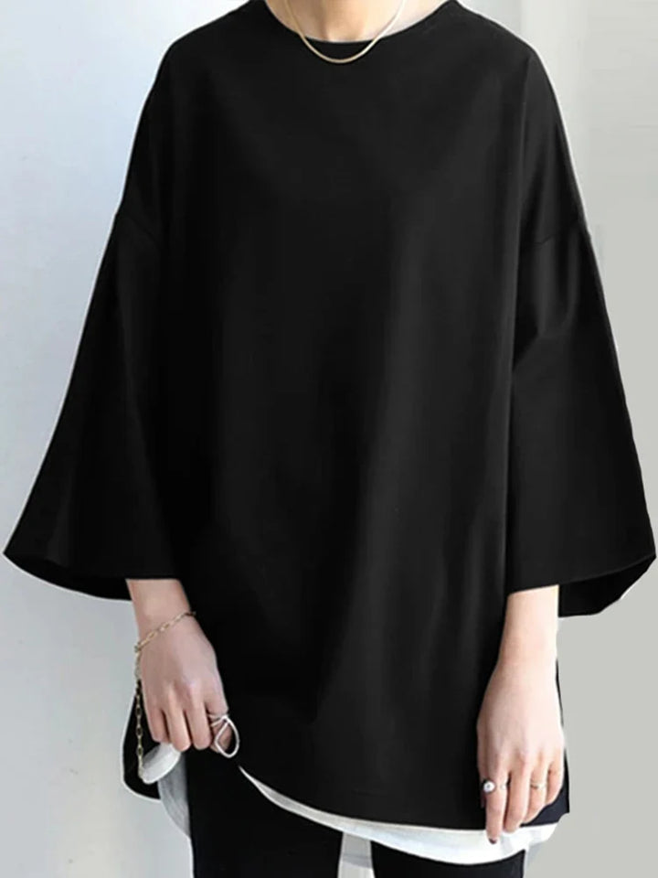 Elegant og komfortabel kvindebluse med lange ærmer og løs pasform. Perfekt til casual hverdagsmode.