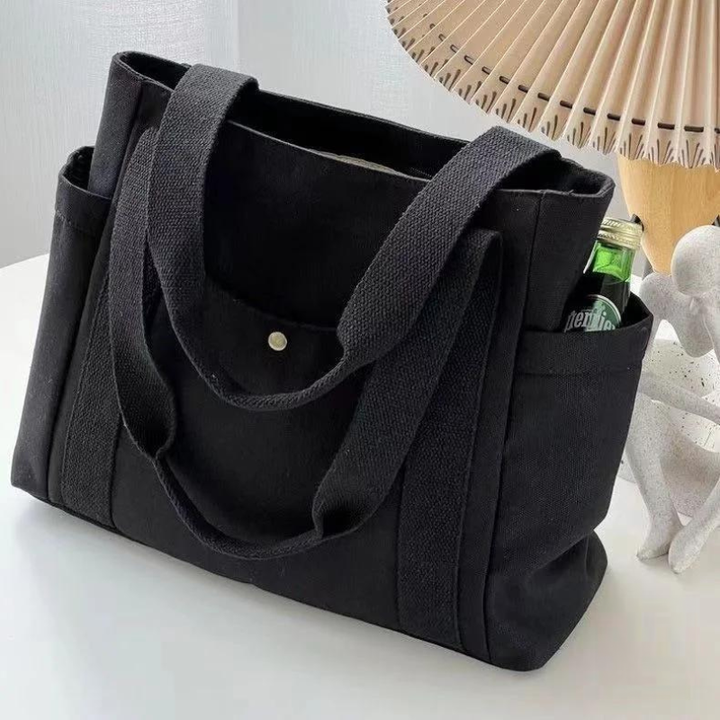 Detalje af rummelig dame tote taske med multi rum; perfekt til at organisere hverdagens fornødenheder.